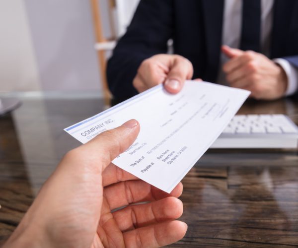 Close-up,Of,A,Businessperson’s,Hand,Giving,Cheque,To,Colleague,At Air duct cleaning cost